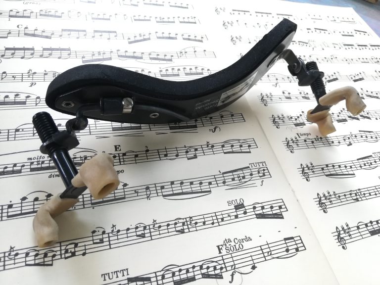a shoulder rest lying on some sheet music